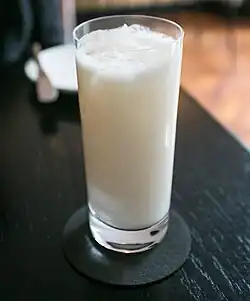 A glass of a coconut-based drink.