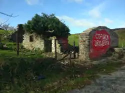 Cofiwch Dryweryn wall from the south after rebuild, October 2020, showing more of building structure after vegetation cleared
