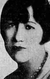 The face of a white woman with short dark hair.