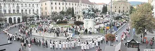 Small photo of people in folk costume in a city square