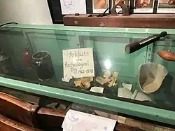 Cabinet at the Crozer Schoolhouse displaying artifacts from the Caleb Pusey House