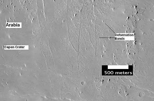 The group of lines running up and down in the image are believed to be deformation bands. They can be thought of as small faults.