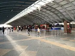 Two planes on the tarmac in front of an airport building