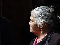 Woman looking to the left with a black background