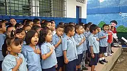 Salvadoran school children singing national anthem