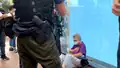 An elderly woman showing signs of discomfort after being stopped and searched by police[42]