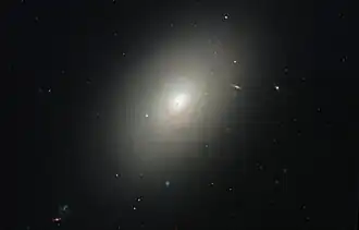Image of a yellow-white elliptical galaxy.