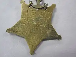 Closeup of star-shaped medal's back side