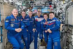 Expedition 57 crew gathers inside the Destiny laboratory on December 18, 2018