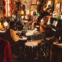 Individual men playing the drums, piano, guitar, trumpet and saxophone in a small and cramped room
