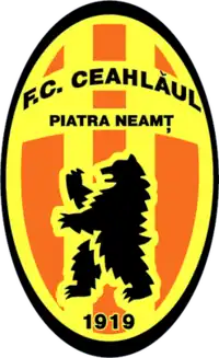 Oval orange-and-yellow team logo, with a stylized bear