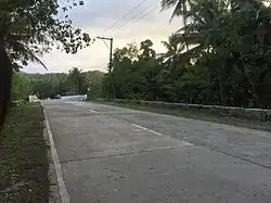 A stretch of road before passing a bridge.