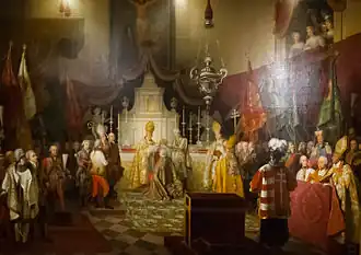 Interior of a Catholic church. Before the altar, kneels a man in a golden robe. A bishop in gilded clothesand a layman in white are holding the Crown of Saint Stephen above his head. Around them stand many bishops and laymen in courtly clothes.