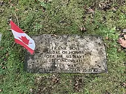 Frank Bois’s headstone with Canadian flag fluttering