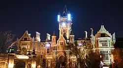 Frankenstein Manor at night with electrical effects in windows.