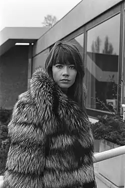 Françoise Hardy in a coat, standing in Amsterdam in 1969