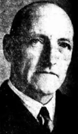 Grainy black and white photograph of a man looking at the camera