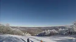 A photograph of the view form the North Face trail on Plattekill Mountain with snow visible