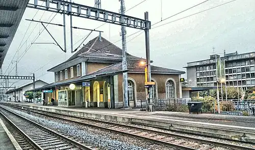 Two-story building with hip roof and single-story wings