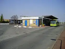 Entrance with a shuttle bus to the airport waiting outside (prior to opening of Line 14 extension)