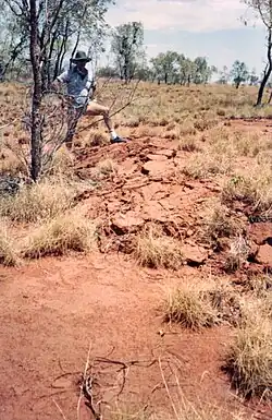 Gavin Carpenter looking at the disturbed earth