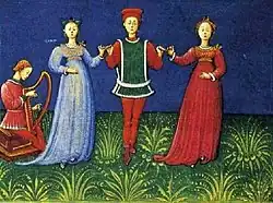 A man dancing with two women to harp music