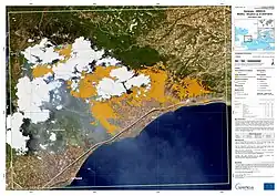 The image shows the fire in Kineta and its aftermath.