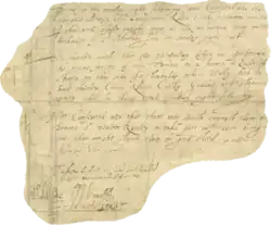 A small irregular section of parchment upon which several lines of handwritten text are visible. Several elaborate signatures bookend the text, at the bottom.