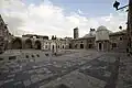 Courtyard of the mosque, with the domed treasury (bayt al-mal) on the right[2]