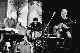 Roger Johansen (drums) live at "Herr Nilsen" (2007), flanked by Hans Mathisen (guitar) to the right and Per Mathisen (bass) to the left.