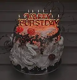 A cake with candles spelling "Happy Burstday" on it