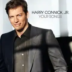 Harry Connick Jr. in a black jacket and black shirt, white background, black text