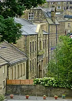 A view of the village from above, with narrow tall houses in typically blackened Yorkshire stone.