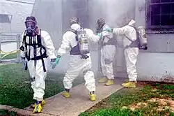 DEA agents wearing Level B hazmat suits.