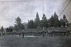 Uniformed men in formation on a field