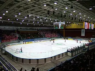 Interior view of an ice hockey arena with a game in progress