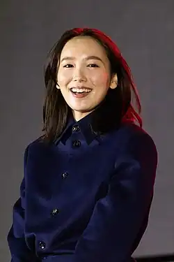 Iitoyo at press event with face turned toward camera
