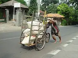 A loaded cargo trike being pushed in Jakarta, Indonesia