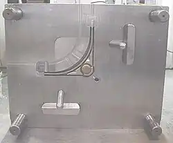 "A" side of die for 25% glass-filled acetal with 2 side pulls