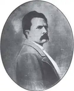 Oval black-and-white portrait of a man with a moustache