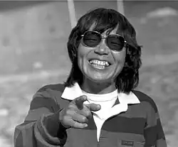 Image of a Japanese woman wearing sunglasses and laughing