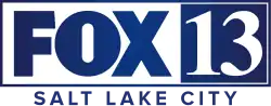 In a white box trimmed in blue, the Fox network logo — the uppercase letters FOX in a sans serif — next to a blue box containing the numeral 13 in a serif. Beneath the box are the words Salt Lake City in a sans serif, tracked slightly wide.