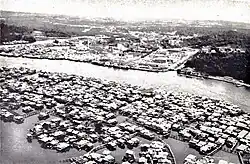 Aerial view of Pusat Bandar (center) and Kampong Ayer (foreground), with the view of Kianggeh River (right) in the 1960s