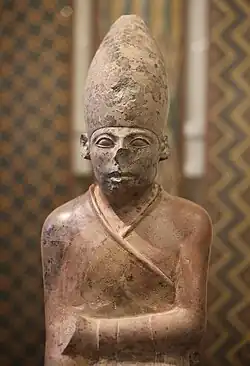 Statue of a seated king wearing the white crown of Upper Egypt
