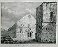 A single-storey Christian church, behind a stone tower