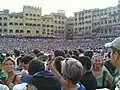 The crowd fills the Piazza del Campo just before departure.