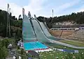 The ski jumps in summer, the outlet area of the large ski slope is used as a swimming pool (2021)