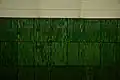 The original underground green side wall tiling and station name reminding of forests