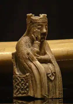 Photograph of an ivory gaming piece depicting a seated queen