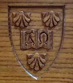 The college's arms on oak wood